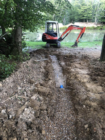 One of our diggers next to a lake on our property